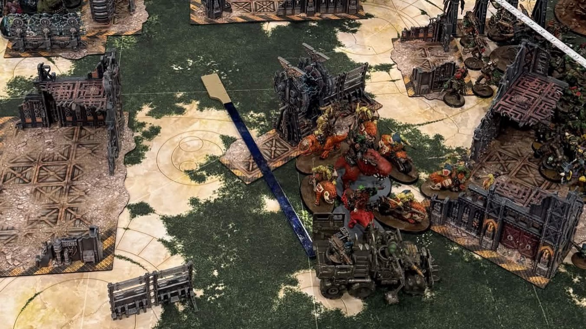 Models and ruins across a tournament table, measured mid move